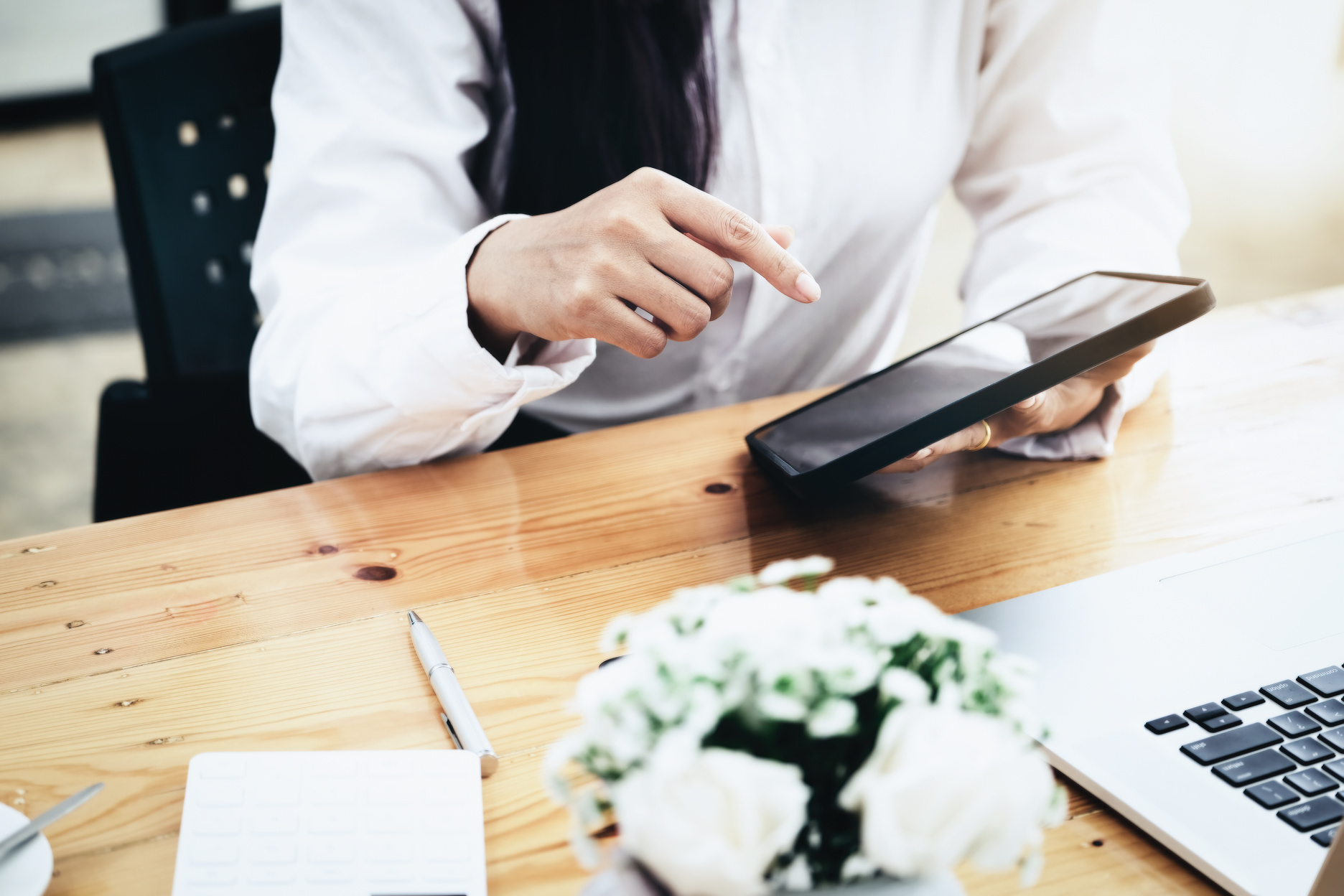 Woman Using Ipad for Working in Office Room.